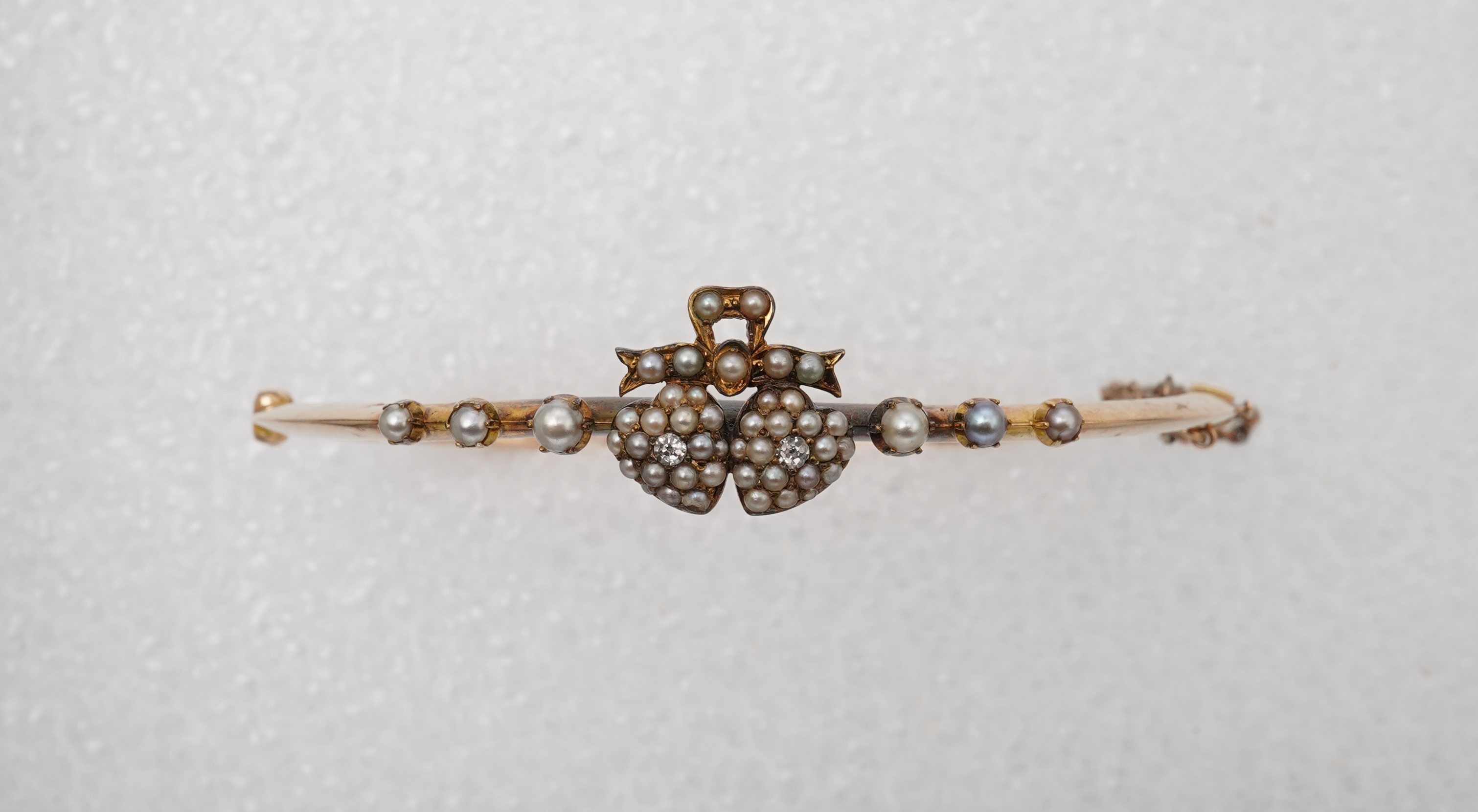 An Edwardian seed pearl and diamond bangle, early 20th century
